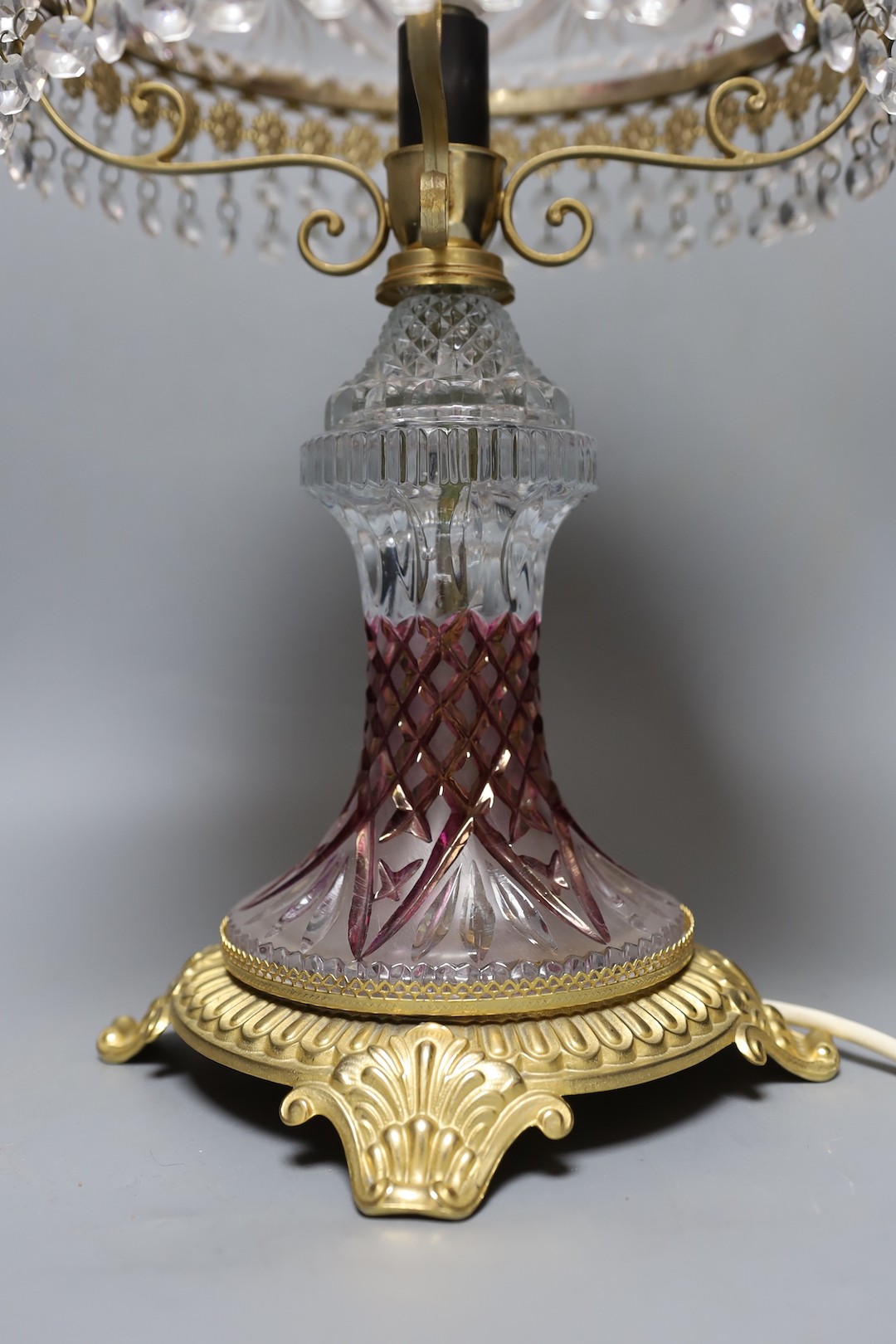 An amethyst flashed cut glass and ormolu table lamp, 58 cms high.